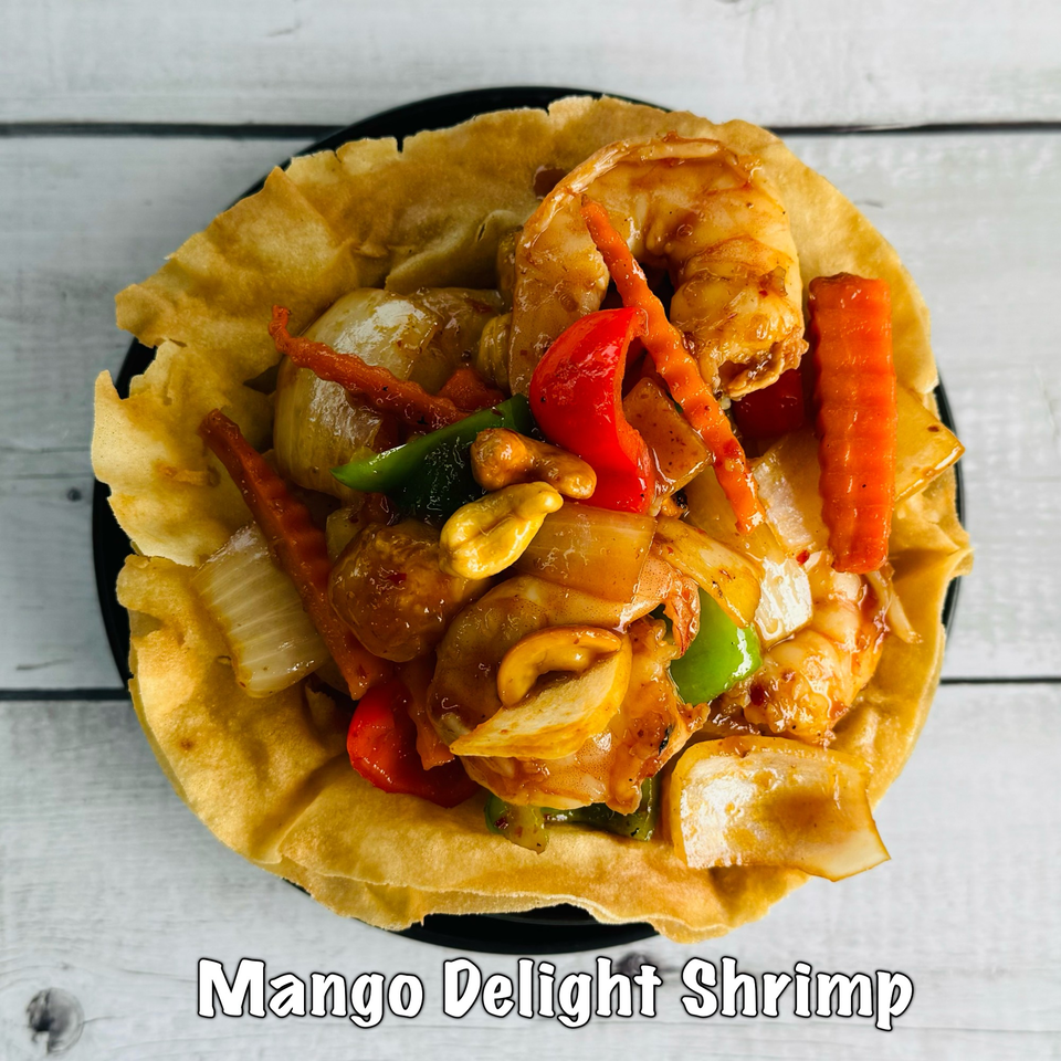 Mango Delight Shrimp, a Thai dish with shrimp, cashews, and vegetables in a crispy edible bowl.